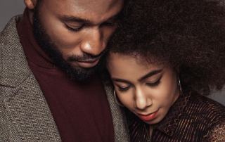 african american retro styled couple hugging isolated on grey