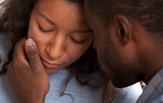 Loving african american husband apologizing comforting sad wife, caring man consoling gently touching face of upset woman, compassion, empathy and support in black couple relationships concept